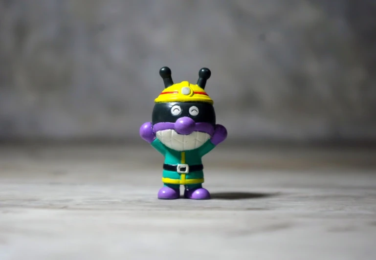 a close up of a toy on a table, inspired by Ei-Q, unsplash, figuration libre, violet ants, guan yu, hamburglar, cartoon character