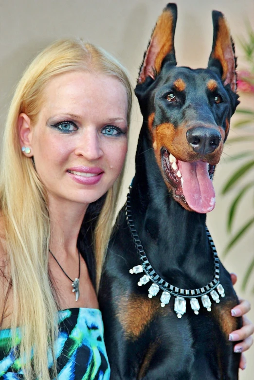 a close up of a person with a dog, by Terese Nielsen, wears a egyptian ankh necklace, professional foto, huge success, german