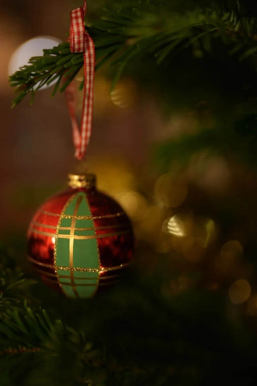 a christmas ornament hanging from a christmas tree, inspired by Ernest William Christmas, pexels, arts and crafts movement, 8k 50mm iso 10, soft light.4k, red and green color scheme, 4k high res
