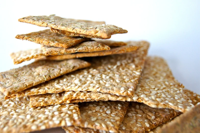 a pile of crackers sitting on top of each other, dau-al-set, luscious with sesame seeds, etsy, skinny, health
