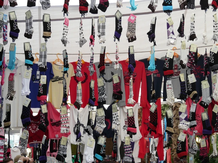 a bunch of socks hanging on a clothes line, a photo, maximalism, vendors, display”, black red white clothes, bedazzled