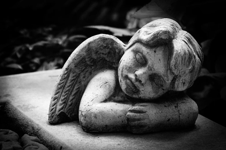 a black and white photo of a statue of an angel, pixabay contest winner, nearly napping, resting on a pillow, mourning family, with beautiful wings