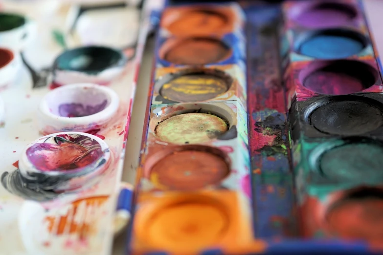 a close up of a box of paint on a table, a watercolor painting, pexels, palettes, 🎨🖌, face painting, museum art