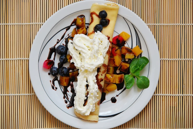 a white plate topped with fruit and whipped cream, by Aleksander Gierymski, flickr, pancakes, rectangular, cone, pasta