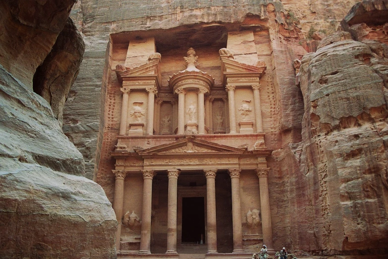 a couple of bikes parked in front of a building, a picture, by Ken Elias, ancient cave, elaborate carved wood balconies, jordan, from wikipedia