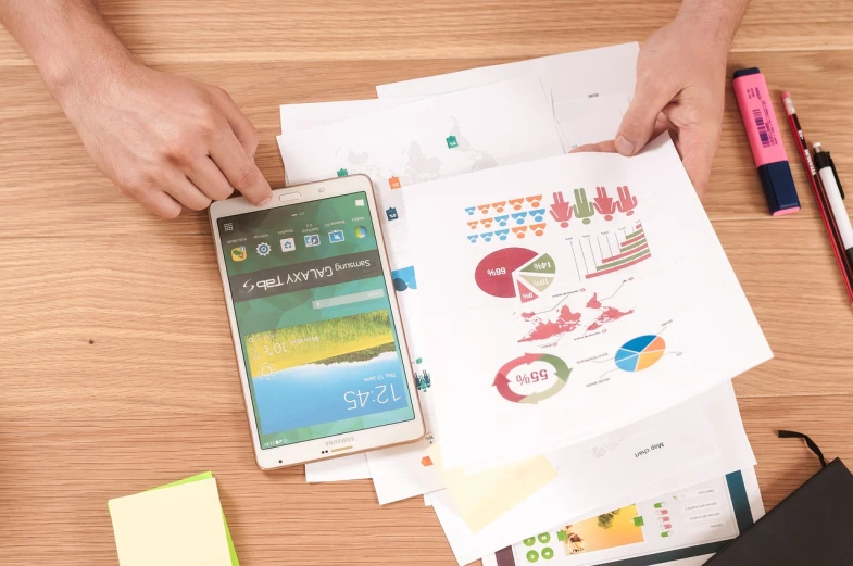 a person sitting at a table with papers and a cell phone, shutterstock, analytical art, green charts, packshot, plan, digital marketing