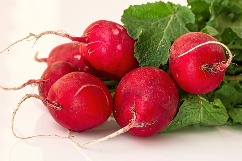 a bunch of radishes on a white surface, by Stefan Gierowski, pixabay, rasquache, close up food photography, istockphoto, aaaaaaaaaaaaaaaaaaaaaa, paul barson