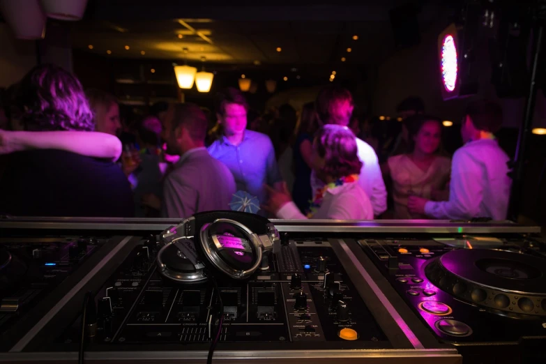 a dj mixing in front of a crowd of people, by Frederik Vermehren, high detail product photo, nightcafe, cable plugged into cyberdeck, are-bure-boke!!!!!!!!