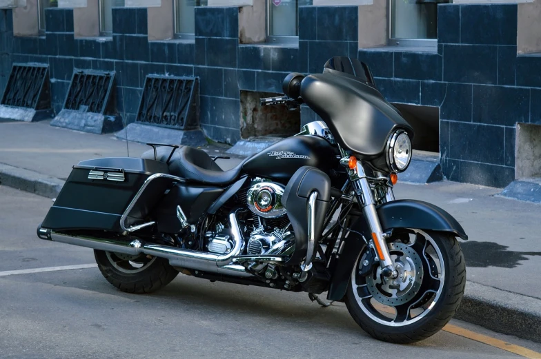 a black motorcycle parked on the side of the road, by Jeffrey Smith, an extremely high quality hd, shiny silver, batman, harley davidson motorbike