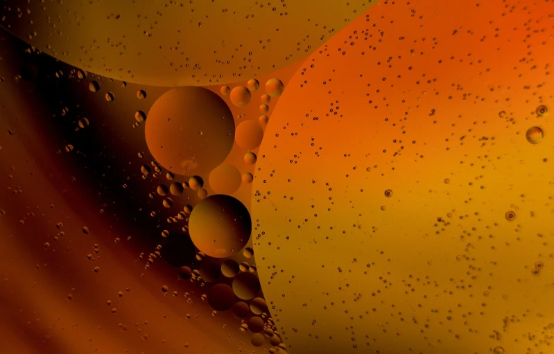 a close up of a mixture of oil and water, a microscopic photo, digital art, orange backgorund, many floating spheres, gas station in space, award winning color photo