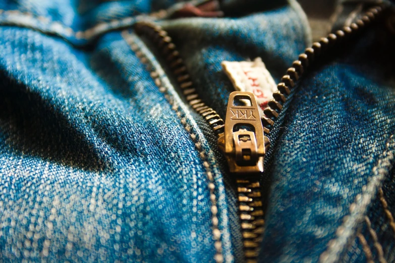 a close up of a zipper on a pair of jeans, by Daniel Ljunggren, pexels, vintage levi ’ s ad, flickr explore 5 0 mm, vintage clothing, open