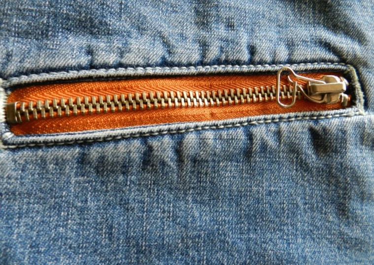 a close up of a zipper on a pair of jeans, a macro photograph, pexels, sōsaku hanga, orange details, seventies, cute huge pockets hardware, stock photograph