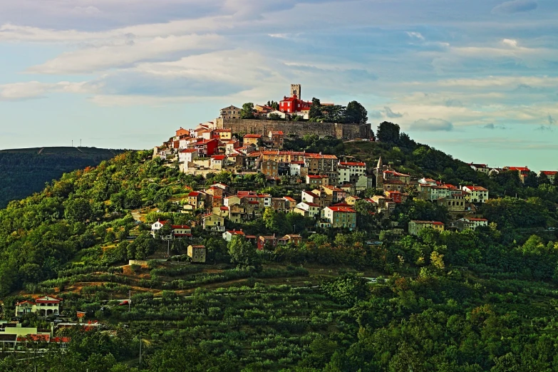 a hill with a castle on top of it, by Mirko Rački, beautiful small town, comfortable, felucia landscape, staggered terraces