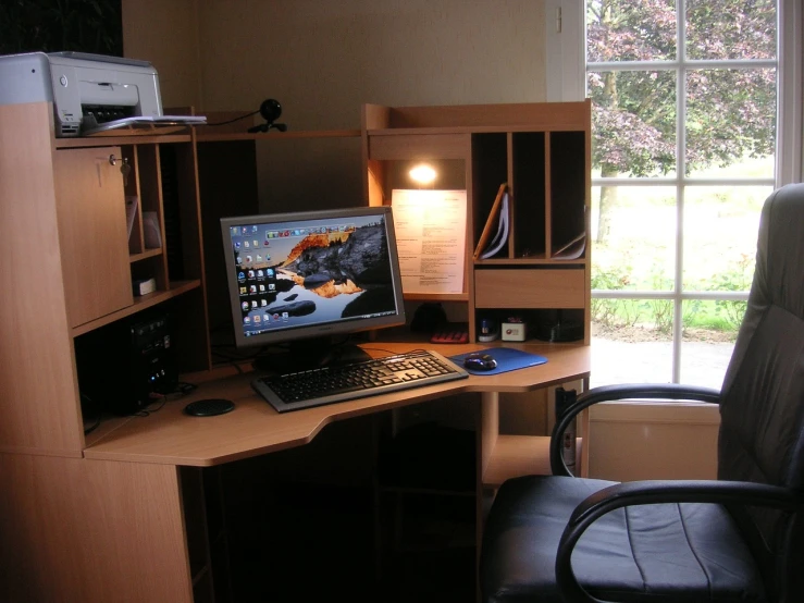 a computer sitting on top of a wooden desk, flickr, looking around a corner, lots of space, corner, elegant study