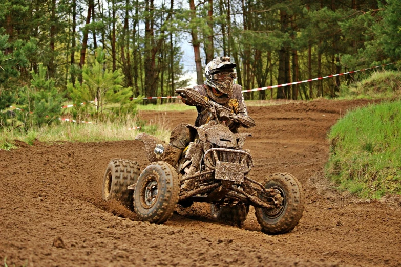 a man riding on the back of a dirt bike, a photo, all terrain vehicle race, detailed and complex, pullitzer winning, brown mud