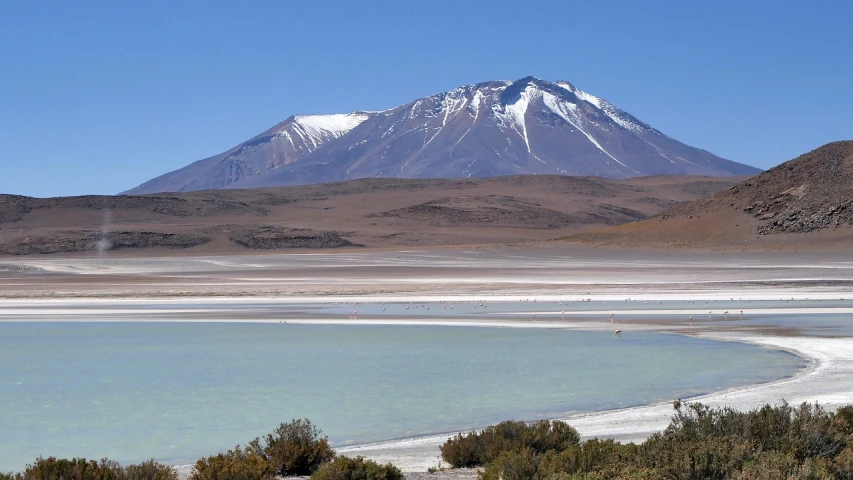 a body of water with a mountain in the background, a photo, by Jonathan Solter, flickr, hurufiyya, constructed upon salar de uyuni, wikimedia commons, andes mountain forest, a beautiful mine