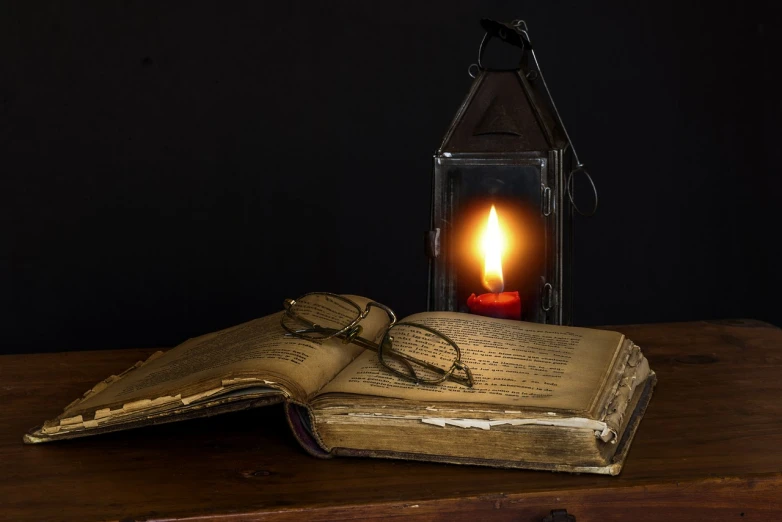 an open book sitting on top of a wooden table, a portrait, by Alexander Fedosav, pixabay, romanticism, one single gas lamp, electrifying, reading glasses, lantern candle