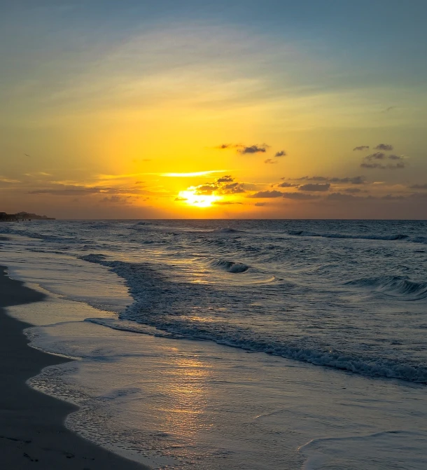the sun is setting over the ocean on the beach, by Felipe Seade, fine art, varadero beach, patches of yellow sky, usa-sep 20, sea breeze rises in the air