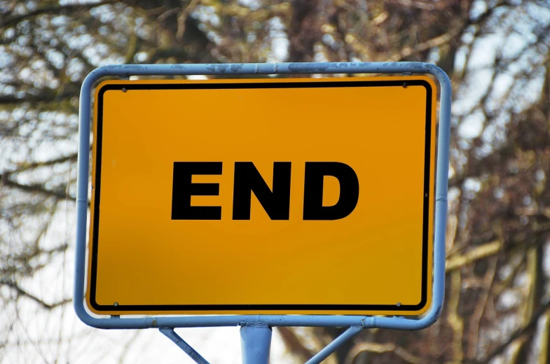 a close up of a street sign with trees in the background, a stock photo, by Wayne England, shutterstock, happening, the endless end beyond all ends, on a yellow canva, dingy, cast