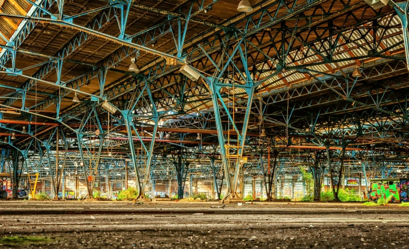 a train that is sitting inside of a building, by Thomas Häfner, shutterstock, abandoned night hangar, truss building, many columns, hdr colors