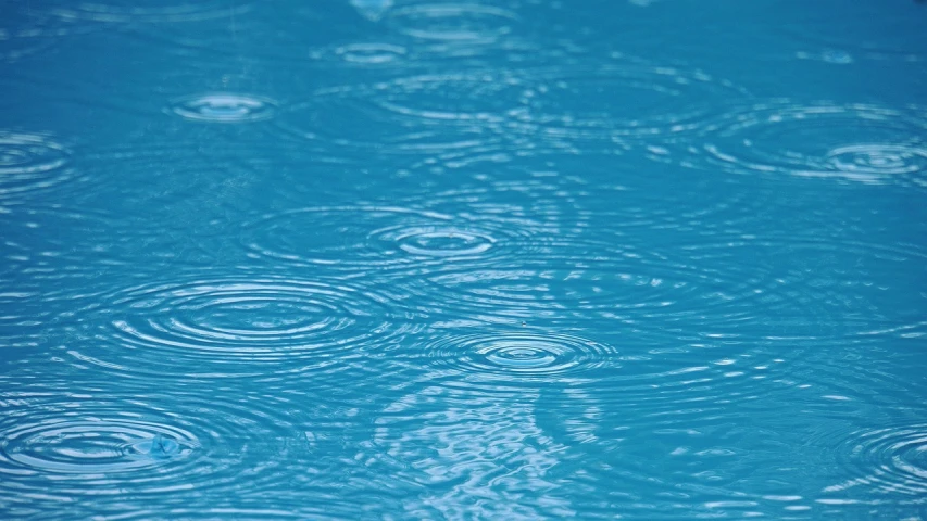 a pool filled with lots of blue water, by Harold von Schmidt, pixabay, minimalism, rain drops, stock footage, b - roll, ultrafine detail ”