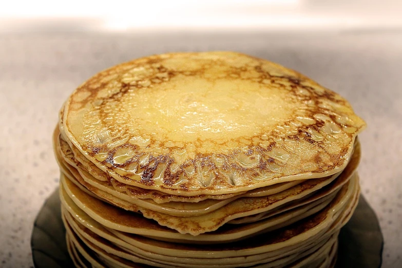 a stack of pancakes sitting on top of a plate, by Dietmar Damerau, flickr, renaissance, stroopwaffel, many golden layers, glaze, grain”