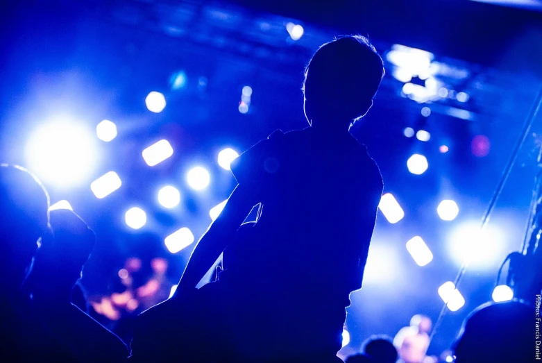 a silhouette of a person standing in front of a stage, by Matt Cavotta, shigeto hirai yuya, good lighted photo, blue mood, childish