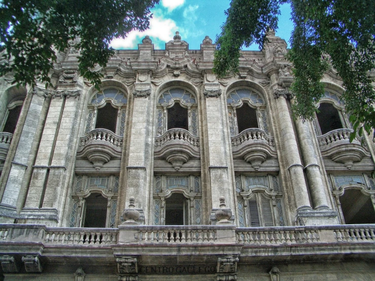a large building with lots of windows and balconies, a digital rendering, by Luis Paret y Alcazar, flickr, baroque, mexico city, stone facade, royal academy, impressive detail : 7
