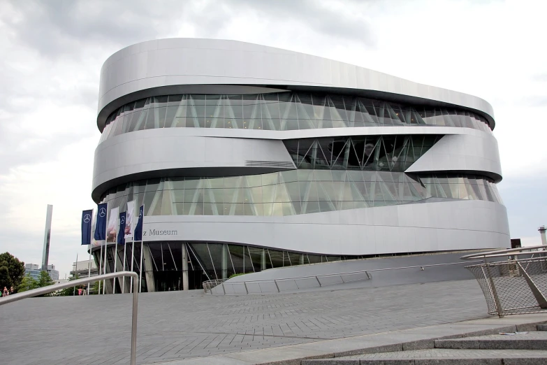 a person on a skateboard in front of a building, inspired by Zaha Hadid, flickr, mercedes, automotive, arena, impressive detail : 7