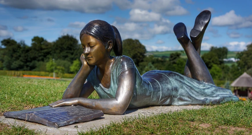 a bronze statue of a woman reading a book, new sculpture, cornwall, dao lee, high resolution, lying down