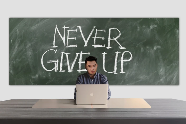 a man sitting in front of a laptop computer, a poster, inspired by Jan Zrzavý, pixabay, never gonna give you up, in a school classroom, darren quach, stock photo