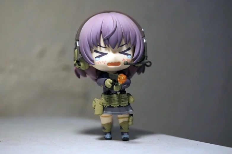 a close up of a toy on a table, a picture, by Jin Homura, infantry girl, very very low quality picture, horrified, miltary