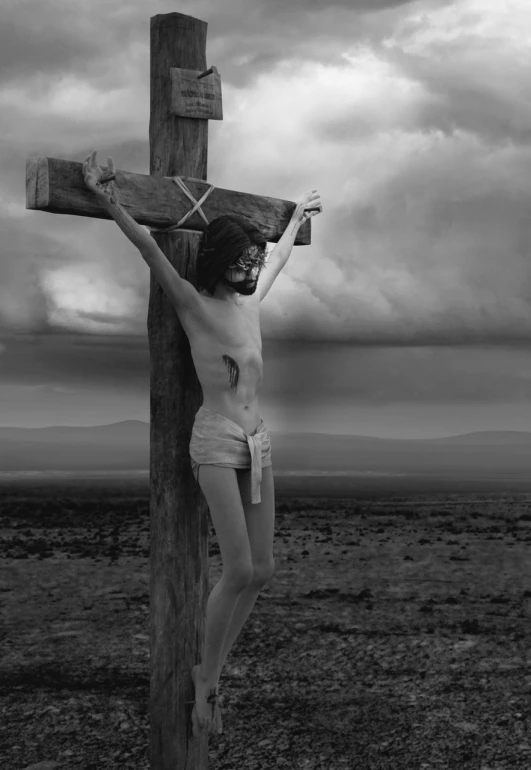 a black and white photo of a woman on a cross, by Artur Tarnowski, fine art, steven meisel photography, dressed like jesus christ, new mexico, sad man