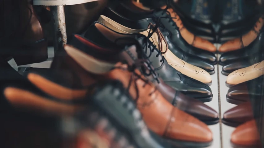 a row of men's shoes sitting next to each other, a screenshot, pexels, thumbnail, handcrafted, video, vintage colours