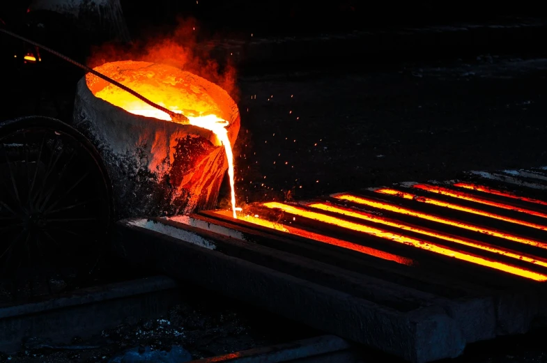 a close up of a piece of metal being poured, a picture, industries, hephaestus, closeup photo, wide shot photo