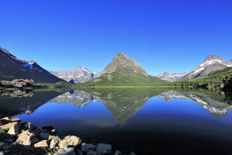 a body of water with mountains in the background, a picture, by Andrei Kolkoutine, pixabay, glacier national park, marvellous reflection of the sky, panoramic photography, extremely clear and coherent