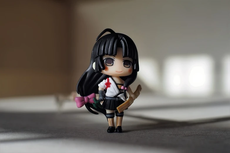 a close up of a doll on a table, by Jin Homura, cute!! chibi!!! schoolgirl, anime girl with a bow and arrow, tifa, 2 4 mm iso 8 0 0
