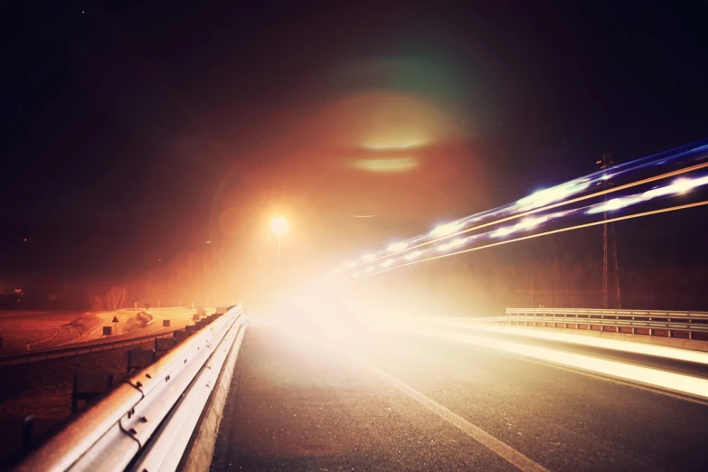 a long exposure photo of a highway at night, a stock photo, shutterstock, happening, optical lens flare fx, postprocessed, guardrail, low resolution