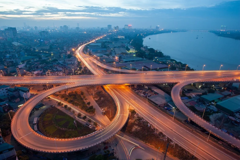 an aerial view of a city at night, a picture, by Bernardino Mei, shutterstock, highway and sunset!!, nezha, phuoc quan, flawless structure