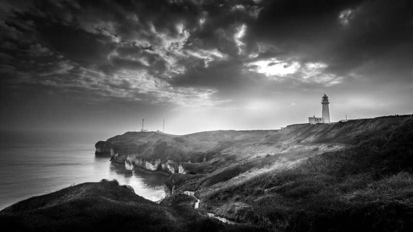 a black and white photo of a lighthouse, a black and white photo, by Andrew Geddes, romanticism, marsden, bay, turbines, landscape vista