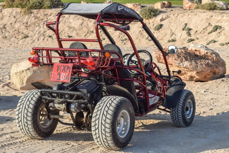 a red buggy sitting on top of a sandy field, a picture, shutterstock, 3 / 4 back view, las vegas, high quality product image”