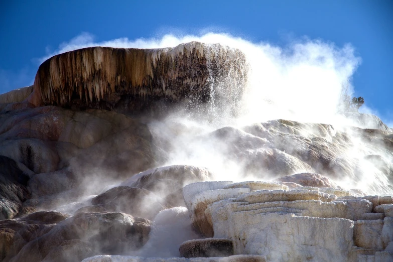 a close up of a waterfall with steam coming out of it, a picture, by Tom Carapic, flickr, romanticism, white travertine terraces, mammoth, abomasnow, amber