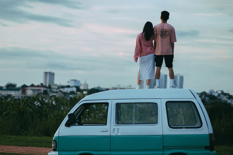 a man and a woman standing on top of a van, pexels contest winner, set on singaporean aesthetic, pink white turquoise, childhood friend vibes, backshot