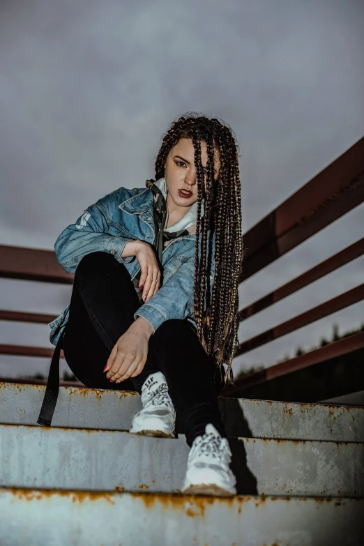 a woman with dreadlocks sitting on a set of stairs, pexels contest winner, antipodeans, white braids, with pop punk style, wearing a jeans jackets, doja cat