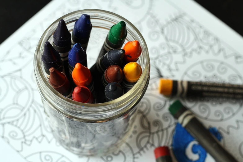 a jar filled with crayons sitting on top of a table, by Maksimilijan Vanka, explore, miscellaneous objects, children, mandalas