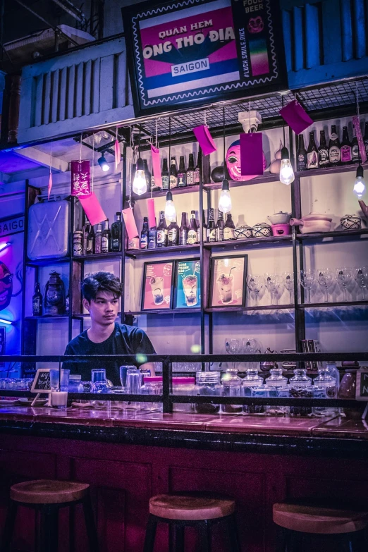 a man that is sitting at a bar, a portrait, by Richard Carline, pexels, process art, japanese akihabara cafe, pink and blue lighting, aussie baristas, in a potion shoppe