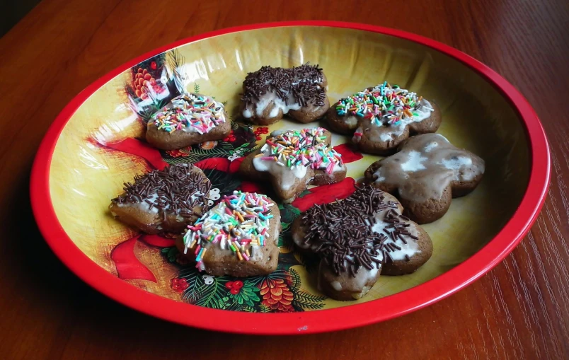 a red bowl filled with donuts covered in frosting and sprinkles, flickr, mingei, gingerbread people, ukrainian, chocolate frosting, unedited