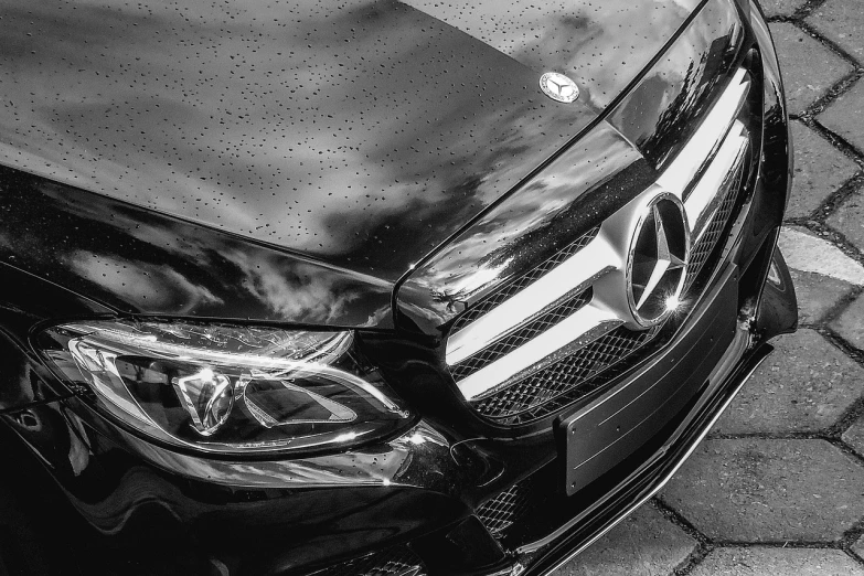 a car that is sitting on the side of the road, a stipple, pexels, photorealism, mercedez benz, monochrome:-2, frontal close up, glossy shiny reflective