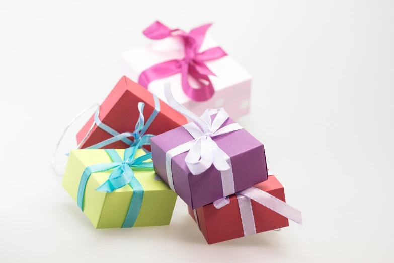 a group of colorful gift boxes sitting next to each other, by Rhea Carmi, pixabay, figuration libre, miniature product photo, purple ribbons, pink white and green, wide shot photo