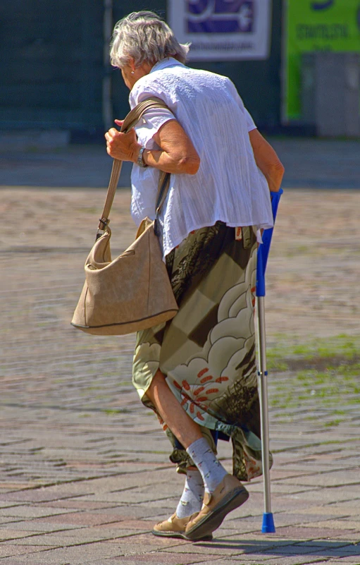 an old woman walking with a bag and crutches, a photo, by Istvan Banyai, pixabay, layered skirts, detailed zoom photo, summer afternoon, mid shot photo